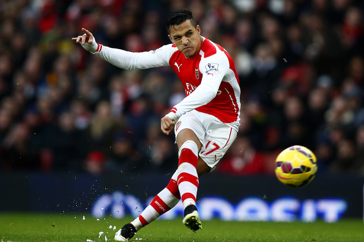 Alexis Sanchez of Arsenal scores his team's third goal during the Barclays Premier League match between Arsenal and Stoke City