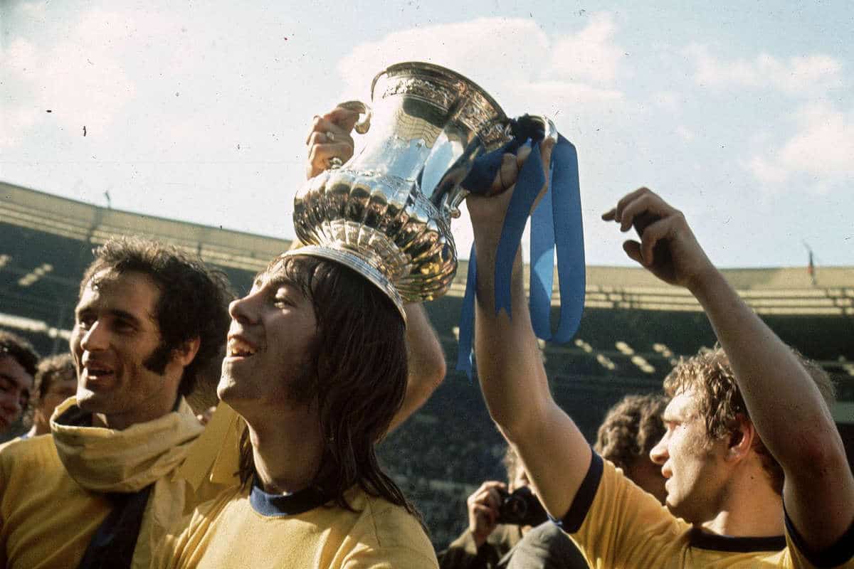 Charlie George lifts the FA Cup trophy for Arsenal