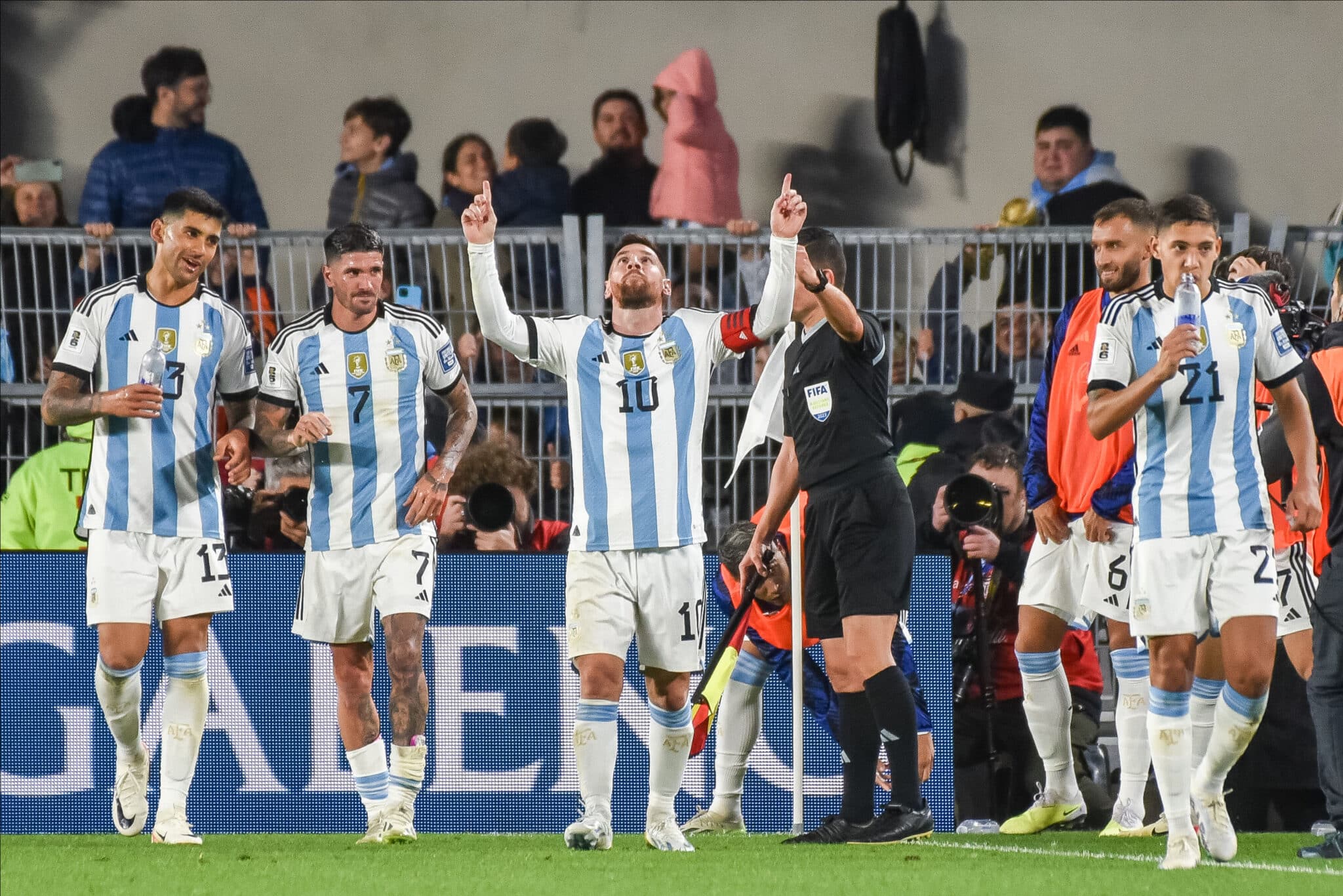 Lionel Messi celebrates with Cristian Romero