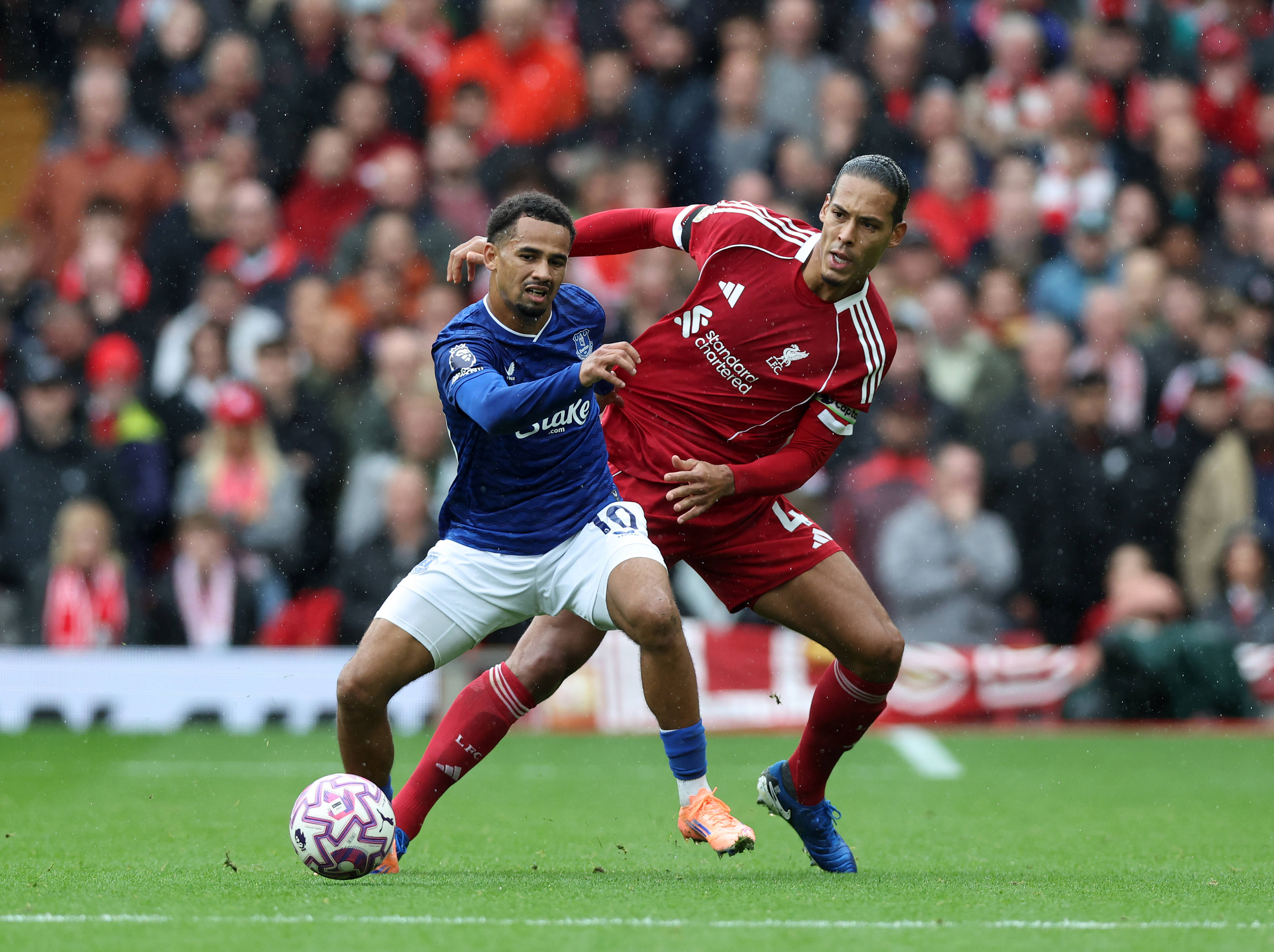 Virgil van Dijk of Liverpool with Iliman Ndiaye of Everton